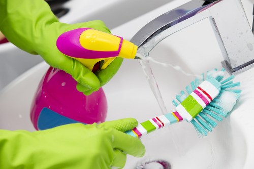 Bathroom tiles being cleaned with natural cleaning agents